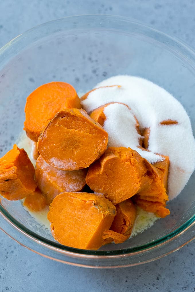 Ruth's Chris Sweet Potato Casserole Recipe | Sweet Potato Casserole | Mashed Sweet Potatoes #sweetpotatoes #casserole #thanksgiving #christmas #holidays #dinner #bajap #sidedish Sweet potatoes, sugar and butter in a bowl.