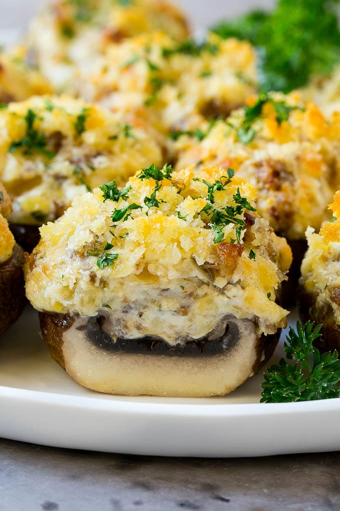 Sausage Stuffed Mushrooms Recipe | Stuffed Mushrooms | Mushroom Appetizer #mushrooms #sausage #appetizer #lowcarb #keto #bajap A cross section of a sausage stuffed mushroom on a serving platter.