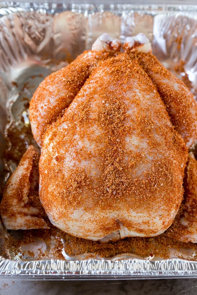 Smoked Chicken Recipe | Whole Smoked Chicken | BBQ Chicken #chicken #smoker #BBQ #dinner #bajap #glutenfree #lowcarb A raw bird is coated with homemade spice rub in a roasting pan.