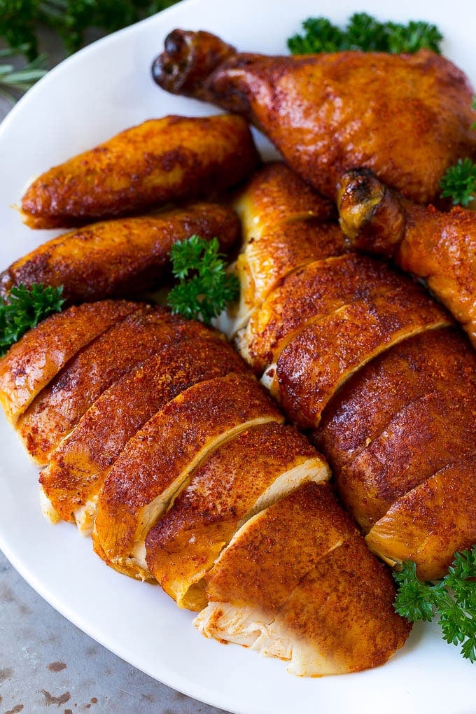 Smoked Chicken Recipe | Whole Smoked Chicken | BBQ Chicken #chicken #smoker #BBQ #dinner #bajap #glutenfree #lowcarb Carved smoked chicken including drumsticks, wings and chicken breasts on a serving platter.