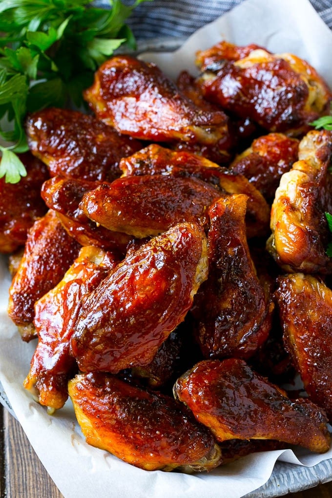 Smoked Chicken Wings | Barbecue Chicken Wings | BBQ Chicken Wings #chicken #wings #bbq #barbecue #appetizer #dinner #bajap Smoked chicken wings brushed with homemade BBQ sauce on a serving plate.