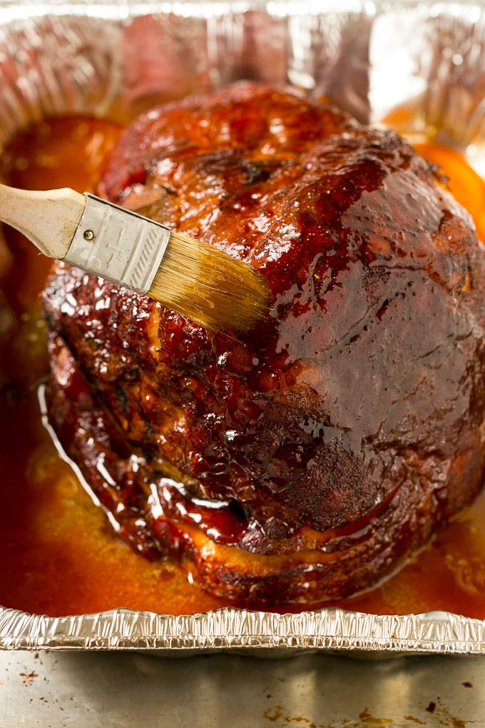 Brown Sugar Smoked Ham Recipe | Holiday Ham Recipe | Brown Sugar Glazed Ham #ham #christmas #thanksgiving #easter #smoker #dinner #brownsugar #bajap #glutenfree Brown sugar glaze brushed on the pork.
