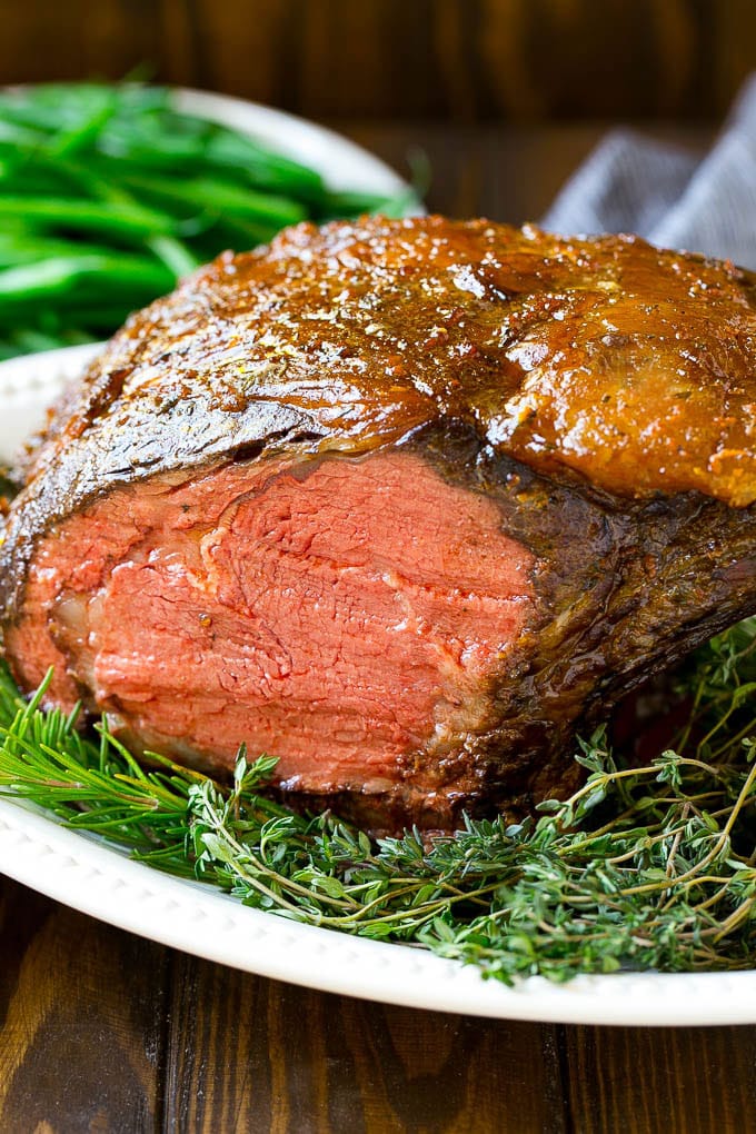 Smoked Prime Rib Recipe | Easy Prime Rib | Smoked Beef | Holiday Prime Rib #primerib #beef #smoker #dinner #bajap #christmas #thanksgiving #lowcarb #keto A smoked prime rib roast cooked to medium rare on a serving platter.