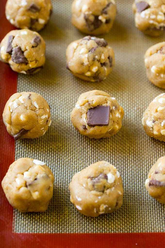 S'mores Cookies Recipe | Marshmallow Cookies #smores #marshmallow #chocolate #cookies #dessert #bajap Balls of cookie dough on a baking sheet.