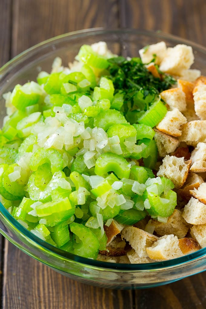 Turkey Stuffing Recipe | Thanksgiving Stuffing | Classic Stuffing #thanksgiving #stuffing #sidedish #fall #bajap Bread cubes, celery, onion and herbs in a mixing bowl.