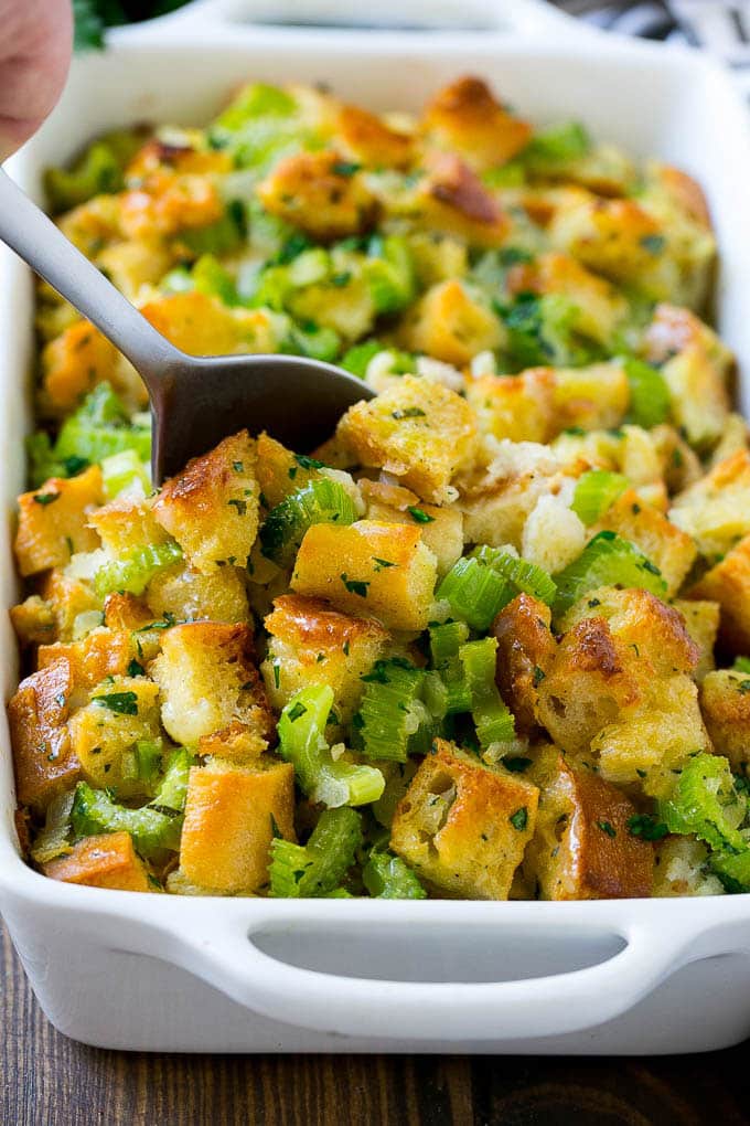 Turkey Stuffing Recipe | Thanksgiving Stuffing | Classic Stuffing #thanksgiving #stuffing #sidedish #fall #bajap Turkey stuffing in a casserole dish with a serving spoon in it.