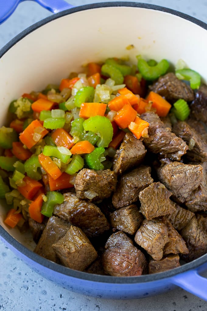 Vegetable Beef Soup Recipe | Beef Vegetable Soup | Beef Soup #beef #veggies #soup #dinner #glutenfree #bajap Beef stew meat, carrots, onion and celery in a pot.