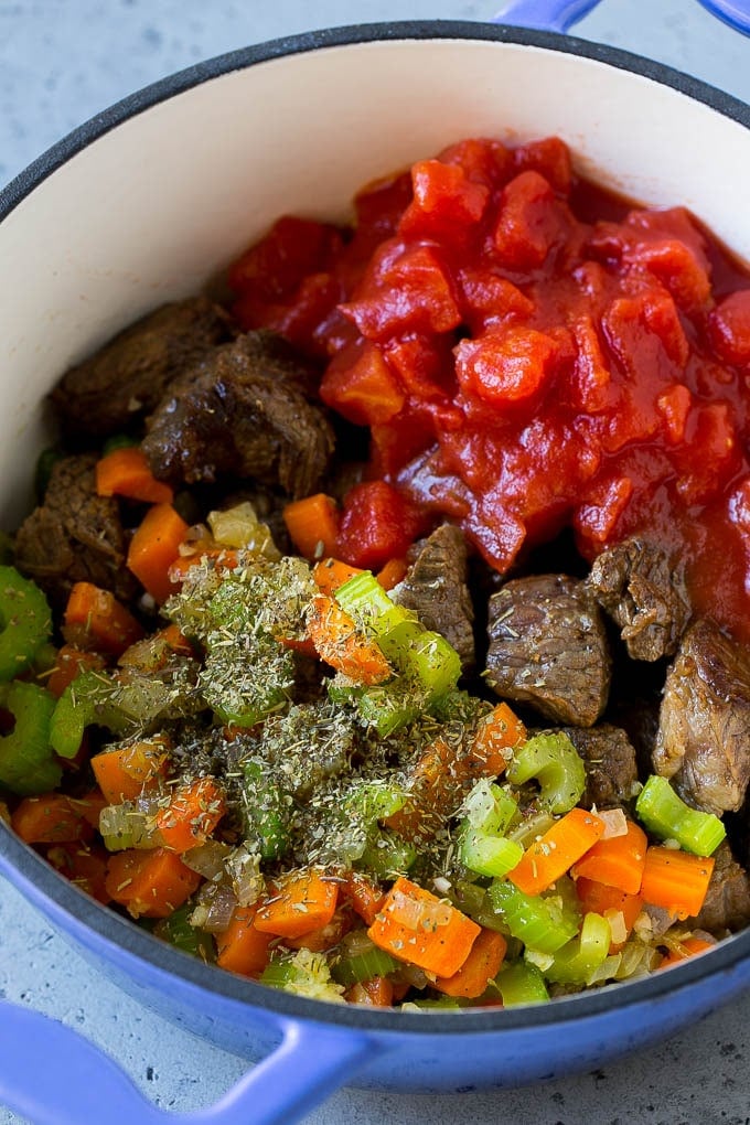 Vegetable Beef Soup Recipe | Beef Vegetable Soup | Beef Soup #beef #veggies #soup #dinner #glutenfree #bajap Stew meat, veggies, tomatoes and herbs in a pot.