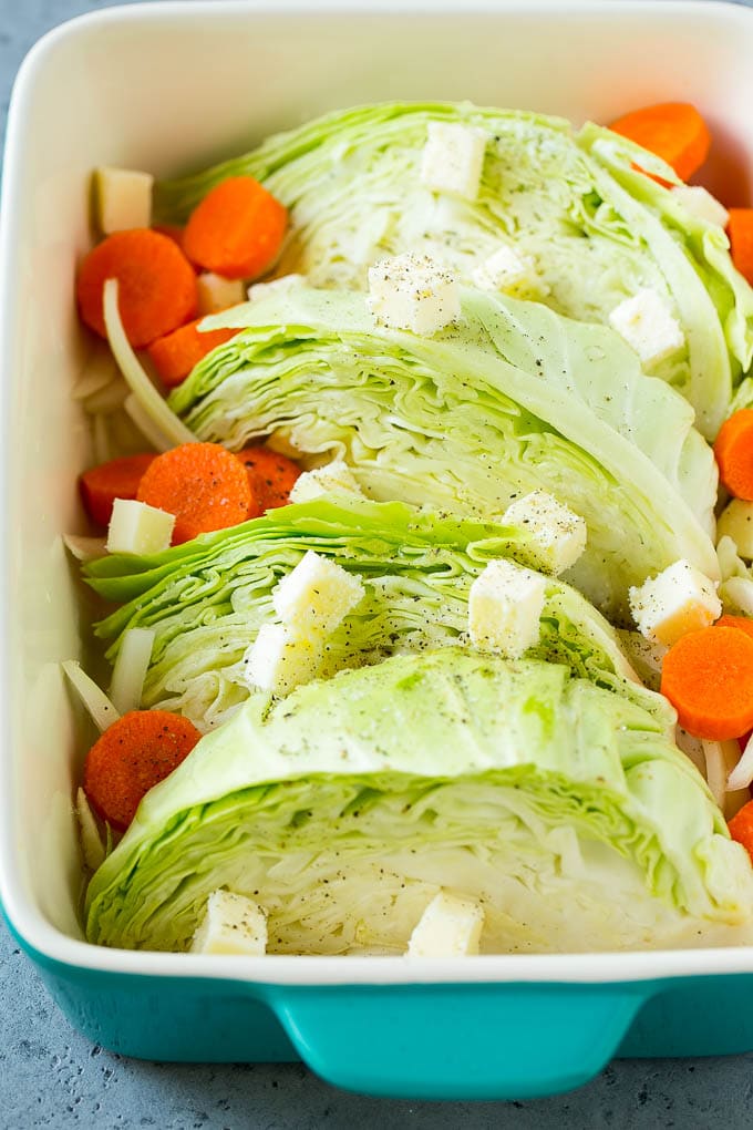 Braised Cabbage Recipe | Easy Cabbage Recipe #cabbage #lowcarb #keto #carrots #veggies #vegetarian #dinner #bajap Cabbage, carrots, onions, pieces of butter and seasonings in a baking dish.