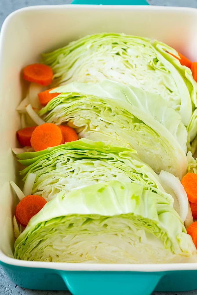 Braised Cabbage Recipe | Easy Cabbage Recipe #cabbage #lowcarb #keto #carrots #veggies #vegetarian #dinner #bajap Wedges of cabbage, sliced carrots and onion in a baking dish.
