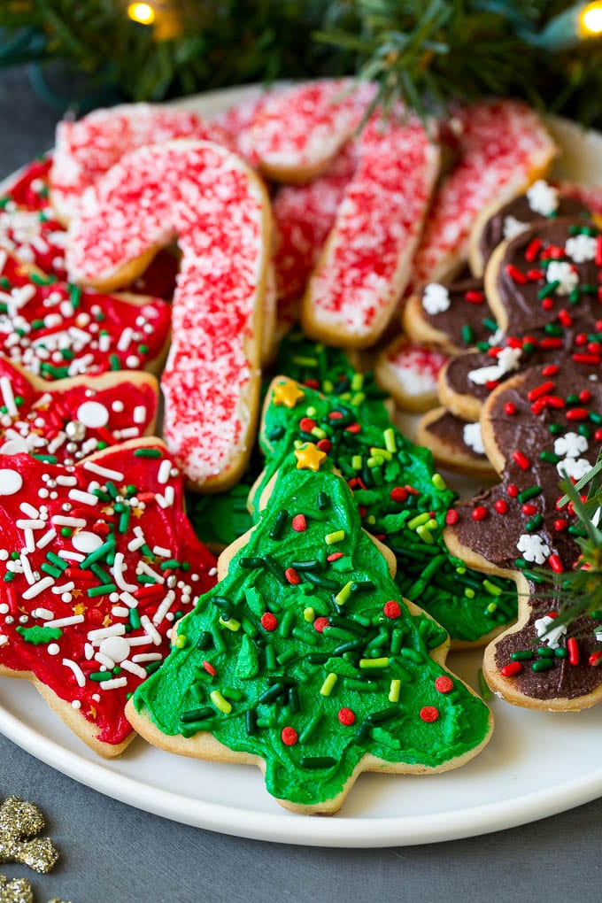 Christmas Sugar Cookies Recipe | Christmas Cookies #cookies #frosting #sprinkles #sugarcookies #christmas #dessert #bajap A serving plate of Christmas sugar cookies decorated with frosting and sprinkles.