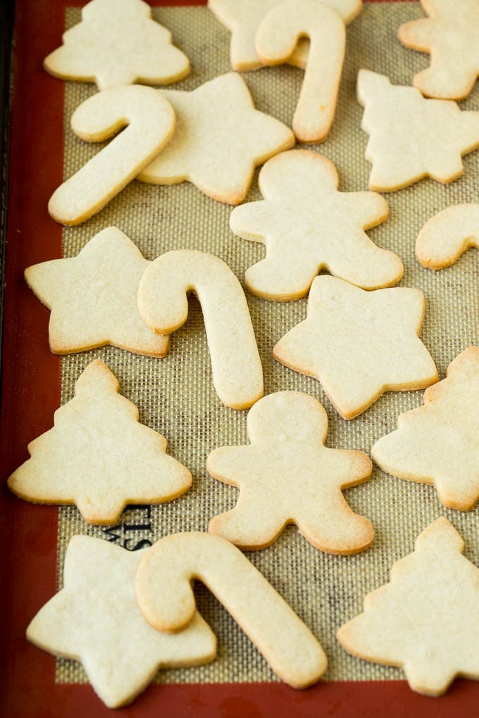 Christmas Sugar Cookies Recipe | Christmas Cookies #cookies #frosting #sprinkles #sugarcookies #christmas #dessert #bajap Cut out cookies on a sheet pan.