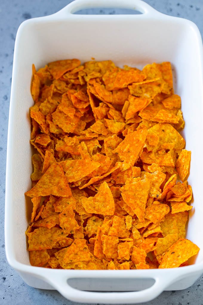 Dorito Casserole Recipe | Mexican Casserole | Beef Casserole #mexicanfood #beef #groundbeef #casserole #dinner #bajap Crushed nacho chips in the bottom of a casserole dish.
