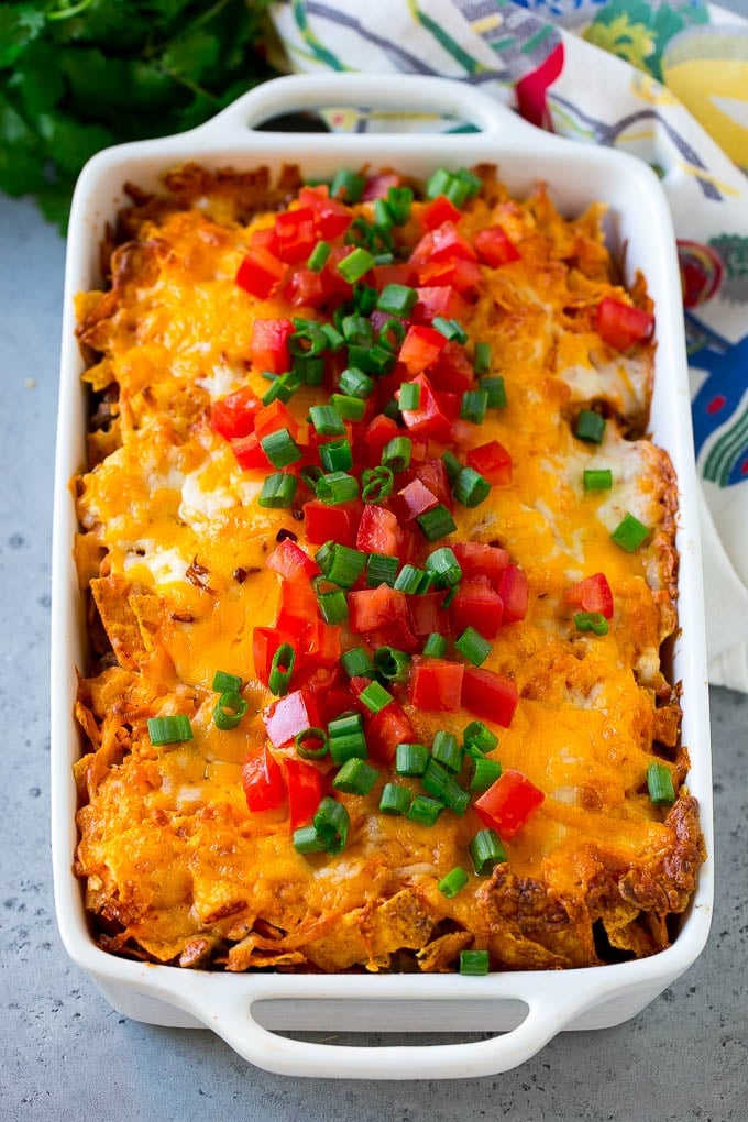 Dorito Casserole Recipe | Mexican Casserole | Beef Casserole #mexicanfood #beef #groundbeef #casserole #dinner #bajap Dorito casserole topped with melted cheese, diced tomatoes and sliced green onions.