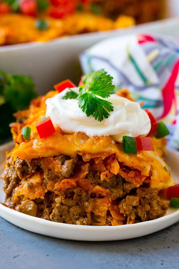 Dorito Casserole Recipe | Mexican Casserole | Beef Casserole #mexicanfood #beef #groundbeef #casserole #dinner #bajap A piece of Dorito casserole with layers of tortilla chips, beef and cheese.