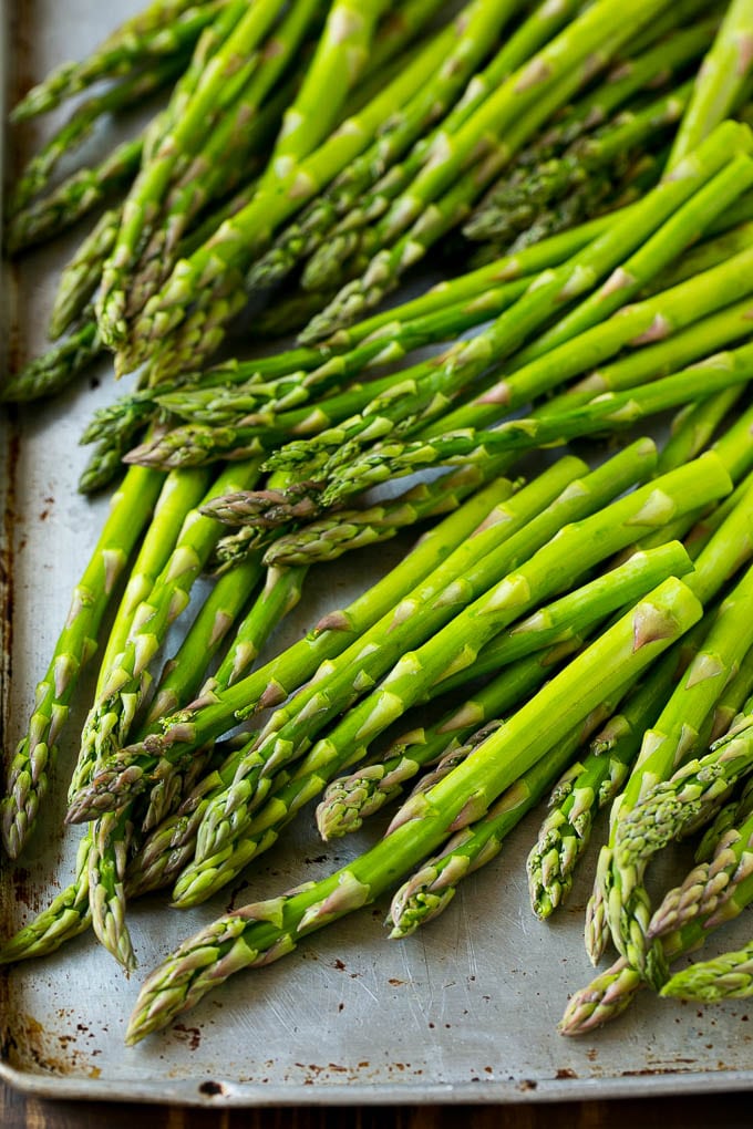 Roasted Asparagus Recipe | Baked Asparagus | Asparagus Side Dish #asparagus #garlic #sidedish #keto #lowcarb #dinner #bajap Raw asparagus spears on a sheet pan.