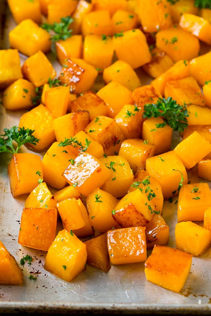 Roasted Butternut Squash Recipe | Baked Butternut Squash | Butternut Squash Side Dish #butternutsquash #squash #fall #vegetarian #dinner #bajap Roasted butternut squash with brown sugar and maple syrup, garnished with chopped parsley.
