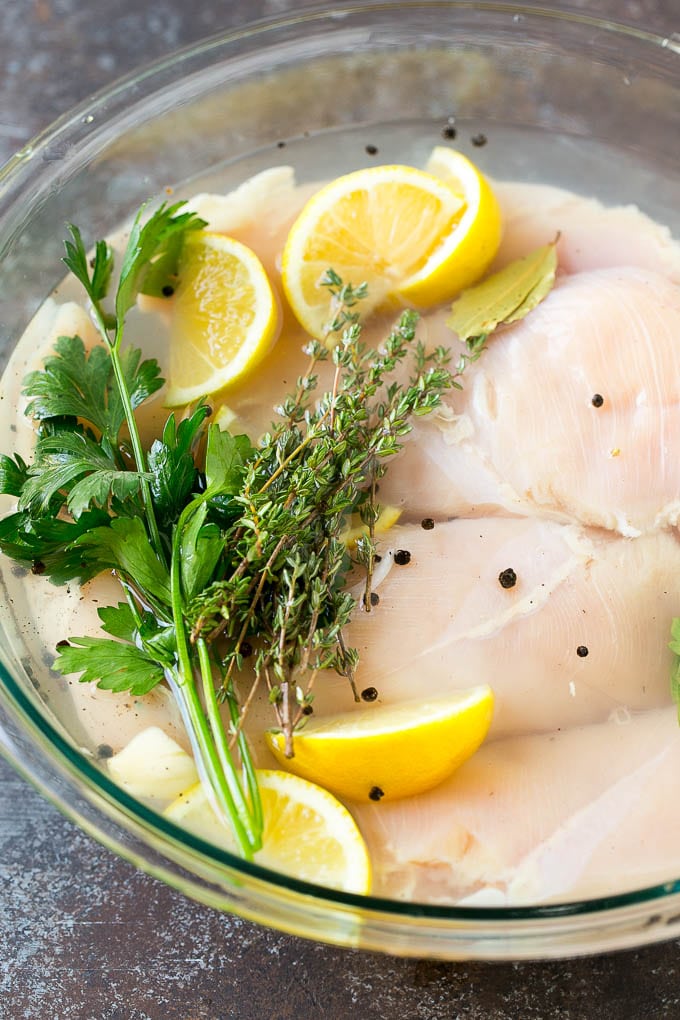 Smoked Chicken Breast Recipe | BBQ Chicken | Smoked Chicken #bbq #chicken #smoker #dinner #glutenfree #bajap Chicken breasts in a bowl of brine with lemon and herbs.