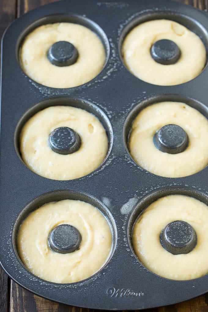 Baked Donuts Recipe | Cake Donuts | Chocolate Donuts | Sprinkle Donuts #donuts #chocolate #sprinkles #breakfast #brunch #bajap A donut pan filled with dough.