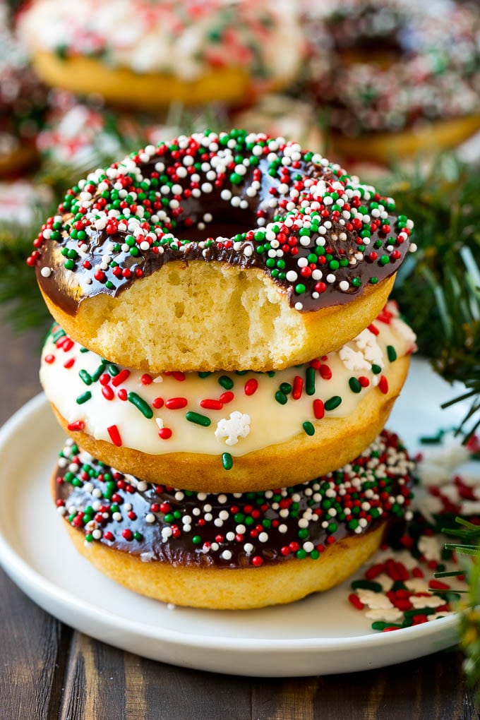 Baked Donuts Recipe | Cake Donuts | Chocolate Donuts | Sprinkle Donuts #donuts #chocolate #sprinkles #breakfast #brunch #bajap A stack of donuts with a bite out of one.