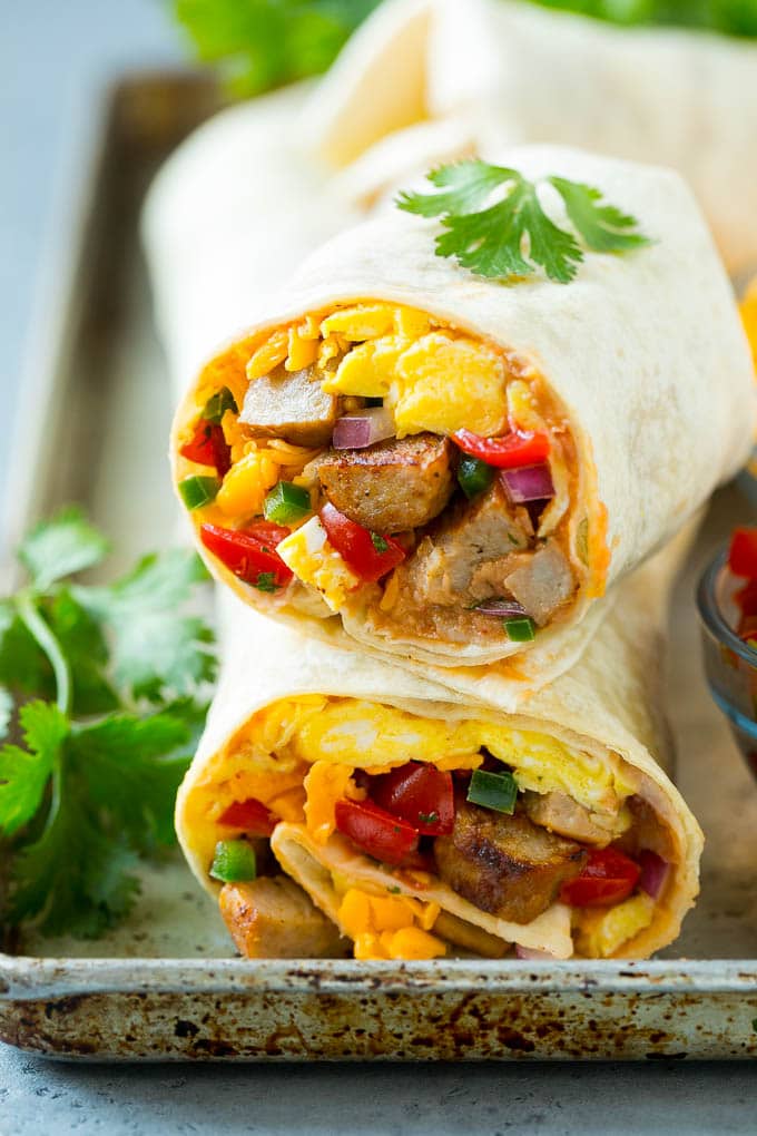 Breakfast Burrito Recipe | Sausage Breakfast Burrito #breakfast #sausage #eggs #burrito #bajap A cross section of a breakfast burrito filled with eggs, sausage, beans and cheese.