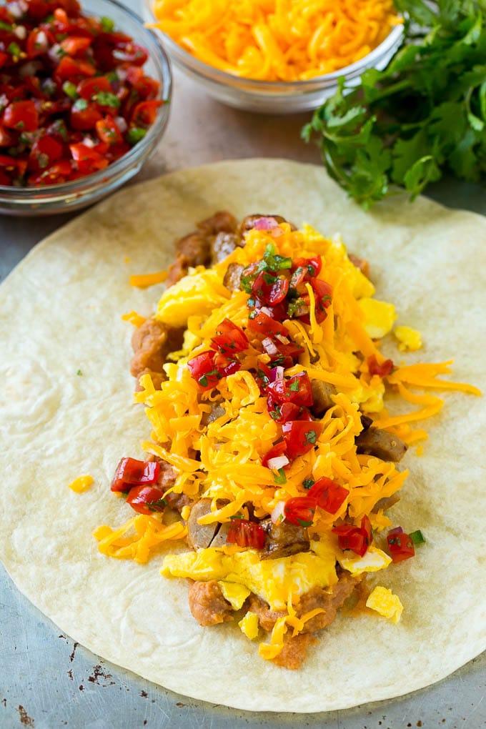 Breakfast Burrito Recipe | Sausage Breakfast Burrito #breakfast #sausage #eggs #burrito #bajap A flour tortilla topped with eggs, sausage, cheese and pico de gallo salsa.