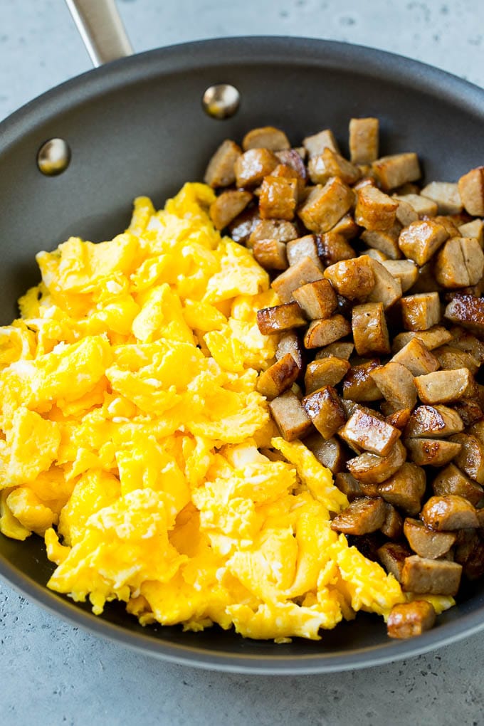 Breakfast Burrito Recipe | Sausage Breakfast Burrito #breakfast #sausage #eggs #burrito #bajap Diced sausage and scrambled eggs in a pan.