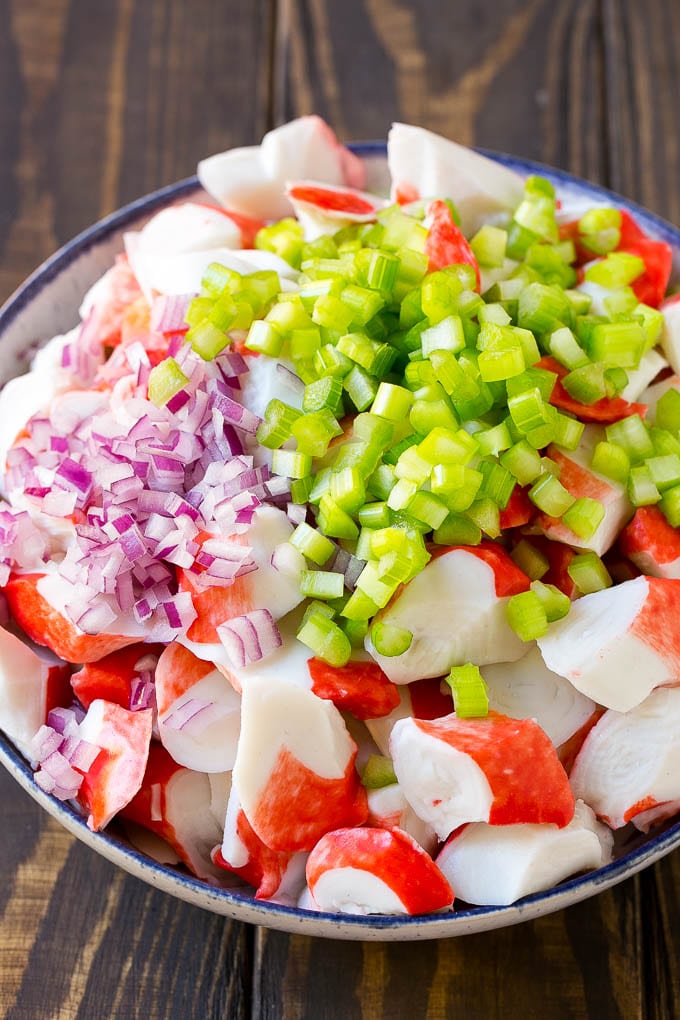 Crab Salad Recipe | Seafood Salad | Deli Salad #crab #salad #seafood #lowcarb #keto #lunch #dinner #bajap Imitation crab, celery and red onion in a serving bowl.