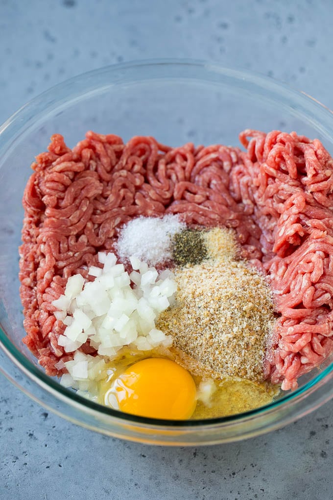 Sweet and Sour Meatballs Recipe | Slow Cooker Meatballs | Crockpot Meatballs | Cocktail Meatballs #meatballs #beef #slowcooker #crockpot #dinner #appetizer #bajap Ground beef, onion, breadcrumbs and seasonings in a bowl.