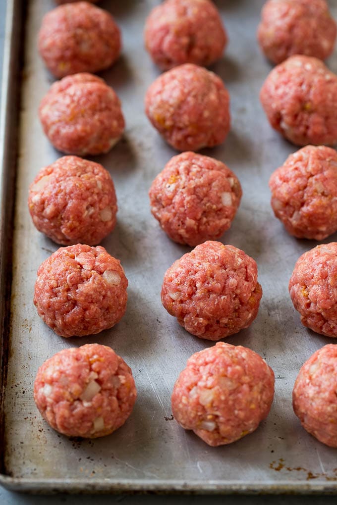 Sweet and Sour Meatballs Recipe | Slow Cooker Meatballs | Crockpot Meatballs | Cocktail Meatballs #meatballs #beef #slowcooker #crockpot #dinner #appetizer #bajap Homemade meatballs on a sheet pan.