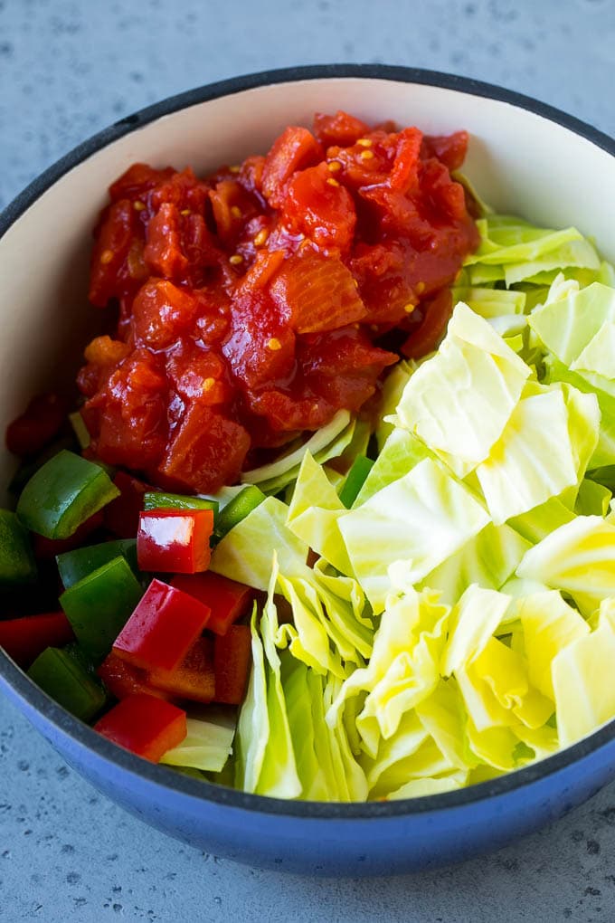 Cabbage Soup Recipe | Vegetable Soup | Veggie Soup | Healthy Soup #soup #healthy #cleaneating #cabbage #vegetables #veggies #dinner #bajap Red and green peppers, diced tomatoes and raw veggies in a large pot.