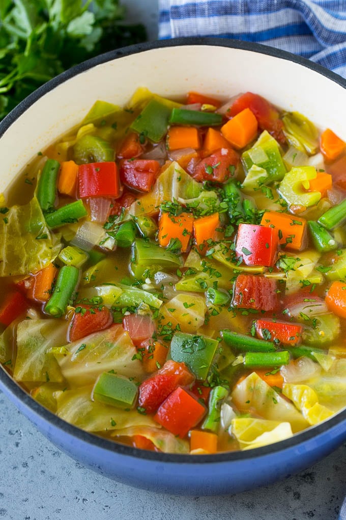Cabbage Soup Recipe | Vegetable Soup | Veggie Soup | Healthy Soup #soup #healthy #cleaneating #cabbage #vegetables #veggies #dinner #bajap A pot of cabbage soup with carrots, celery, bell peppers and green beans.