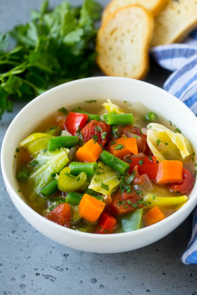 Cabbage Soup Recipe | Vegetable Soup | Veggie Soup | Healthy Soup #soup #healthy #cleaneating #cabbage #vegetables #veggies #dinner #bajap A bowl of cabbage soup with carrots, celery and tomatoes in broth.