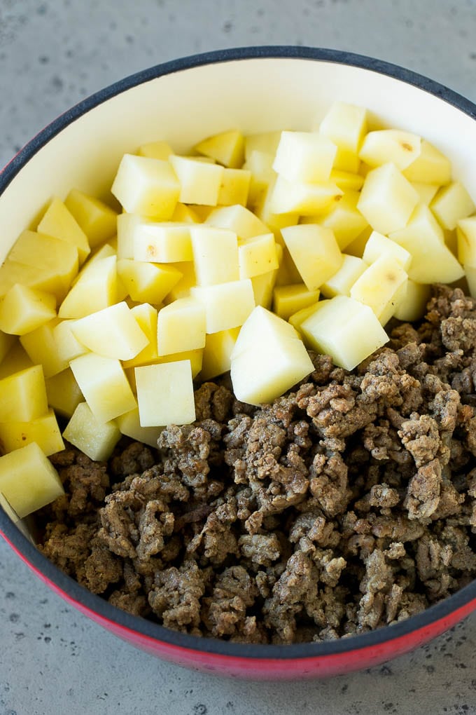 Cheeseburger Soup Recipe | Hamburger Soup | Cheese Soup #soup #groundbeef #hamburger #cheese #bacon #dinner #bajap Cooked ground beef and potatoes in a pot.
