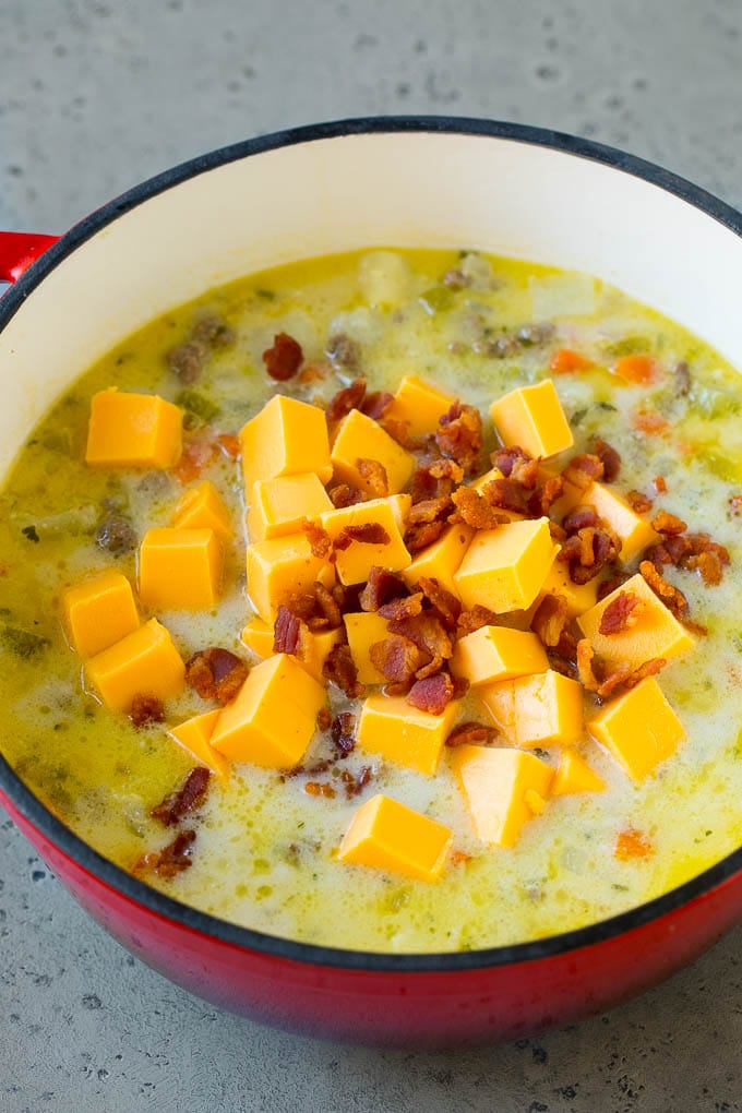 Cheeseburger Soup Recipe | Hamburger Soup | Cheese Soup #soup #groundbeef #hamburger #cheese #bacon #dinner #bajap Potato soup base with cubes of Velveeta cheese and bacon being stirred in.