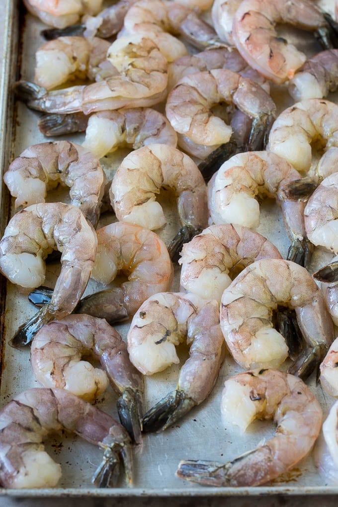 Coconut Shrimp Recipe | Fried Shrimp | Shrimp Appetizer #shrimp #coconut #appetizer #seafood #dinner #bajap Large raw tail-on shrimp arranged on a sheet pan.