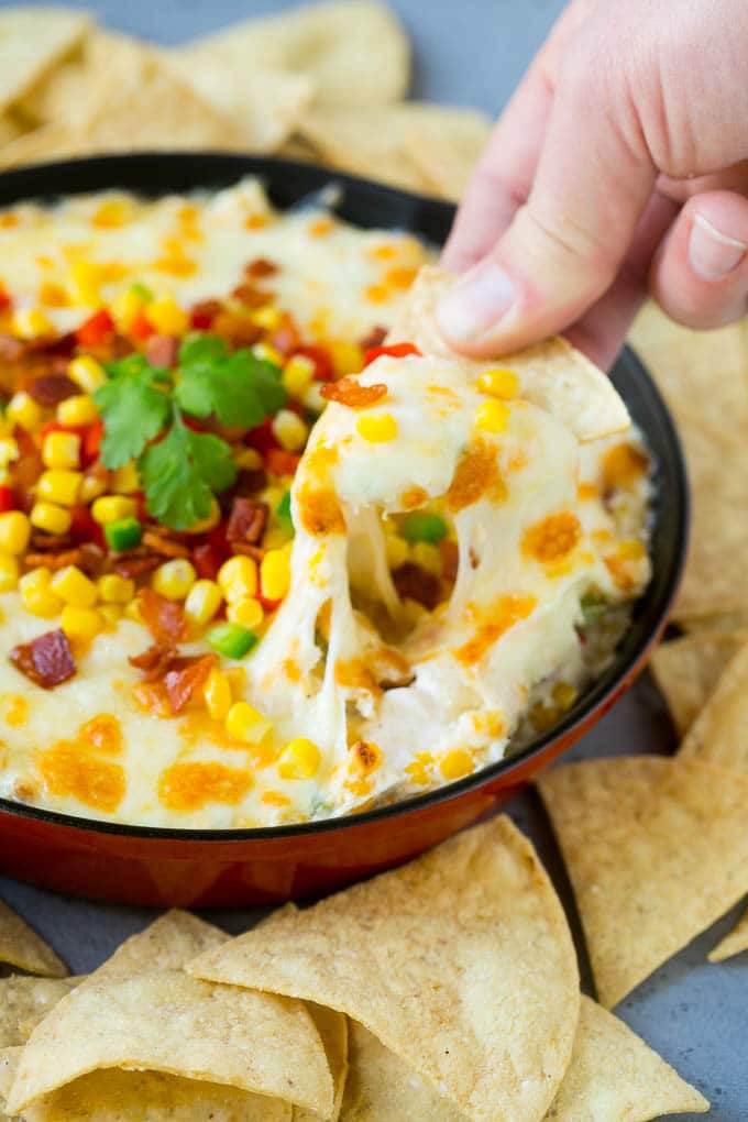 Corn Dip Recipe | Hot Cheese Dip | Bacon Dip #corn #dip #bacon #cheese #appetizer #snack #bajap A chip scooping up a serving of corn dip.