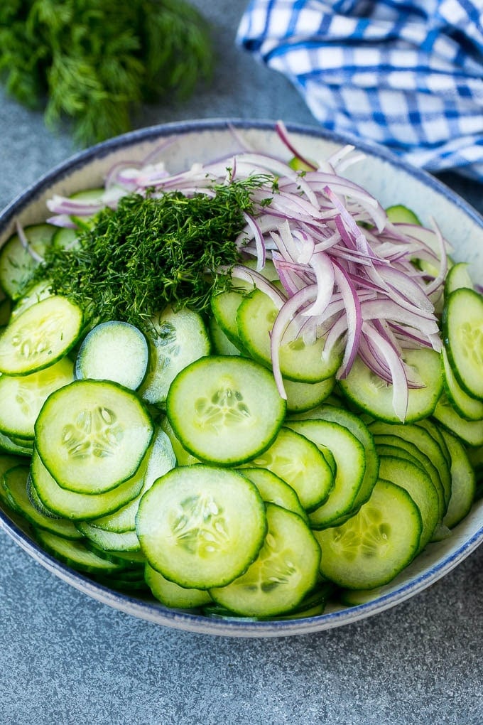 Creamy Cucumber Salad Recipe | German Cucumber Salad | Cucumber Salad #cucumber #salad #dinner #lunch #bajap #cucumbersalad Thinly sliced cucumbers, red onion and fresh dill in a mixing bowl.