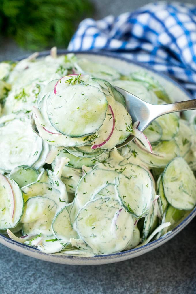 Creamy Cucumber Salad Recipe | German Cucumber Salad | Cucumber Salad #cucumber #salad #dinner #lunch #bajap #cucumbersalad A spoon serving up a portion of creamy cucumber salad.
