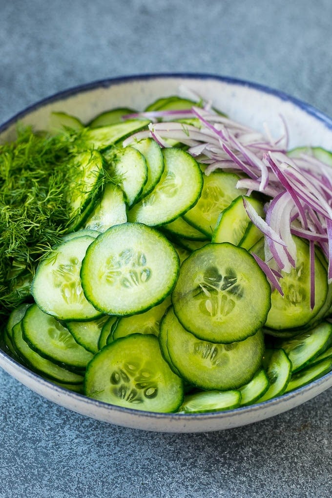 Cucumber Salad Recipe | Cucumber Dill Salad | Cucumber Recipe #cucumbers #salad #glutenfree #sidedish #bajap Ingredients including red onion and dill in a bowl.