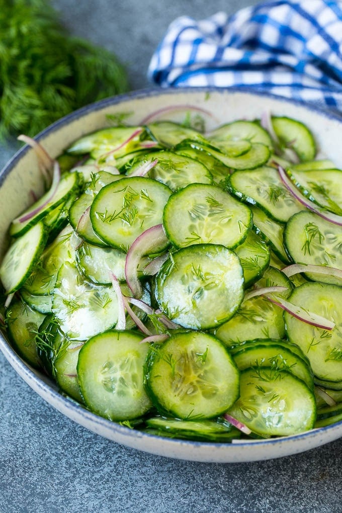 Cucumber Salad Recipe | Cucumber Dill Salad | Cucumber Recipe #cucumbers #salad #glutenfree #sidedish #bajap A bowl of cucumber salad with red onion, thinly sliced cucumbers and chopped dill.