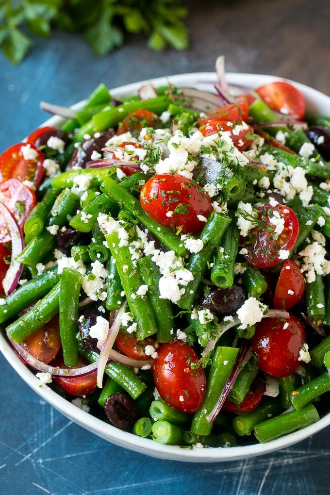 Green Bean Salad Recipe | String Bean Salad | Chopped Salad #greenbeans #tomatoes #olives #salad #cleaneating #lowcarb #glutenfree #bajap A bowl of green bean salad made with feta cheese, tomatoes, red onion and kalamata olives.