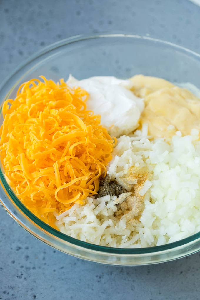 Hash Brown Casserole | Potato Casserole | Hash Brown Side Dish #potatoes #cheese #casserole #sidedish #bajap A bowl of potato shreds, cheese, cream of chicken soup, sour cream and seasonings.