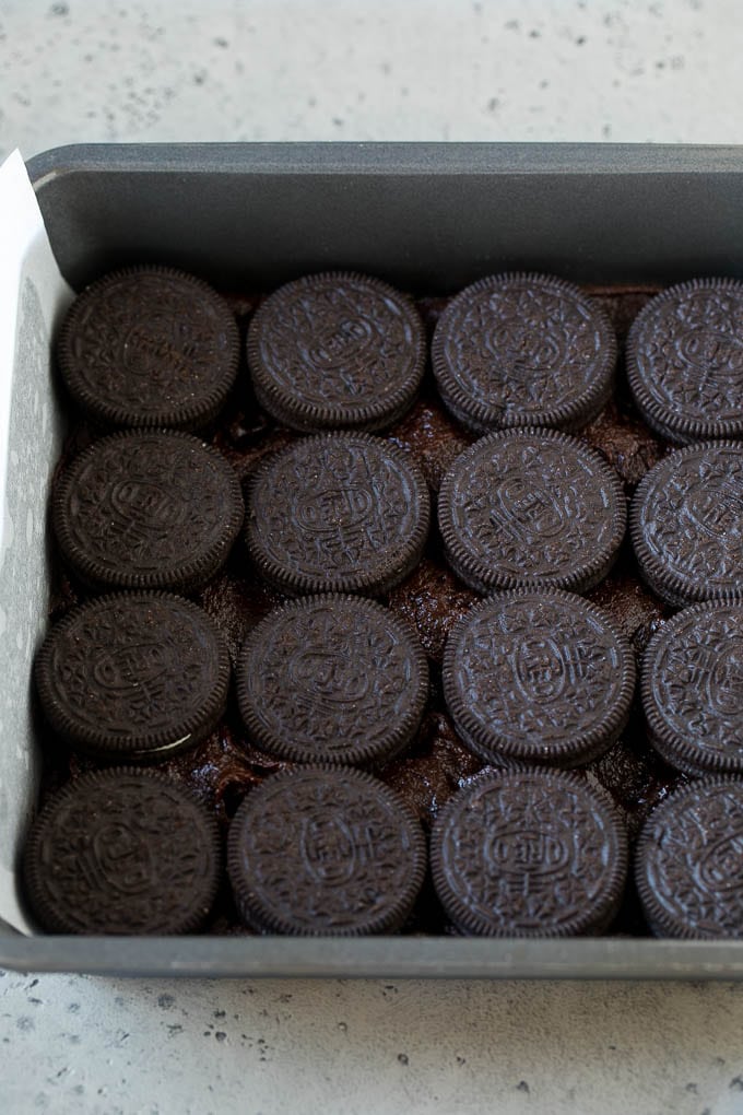 Oreo Brownies Recipe | Homemade Brownies | Chocolate Chip Brownies #brownies #oreos #chocolate #dessert #sweets #bajap A layer of brownie batter with a layer of Oreo cookies on top.