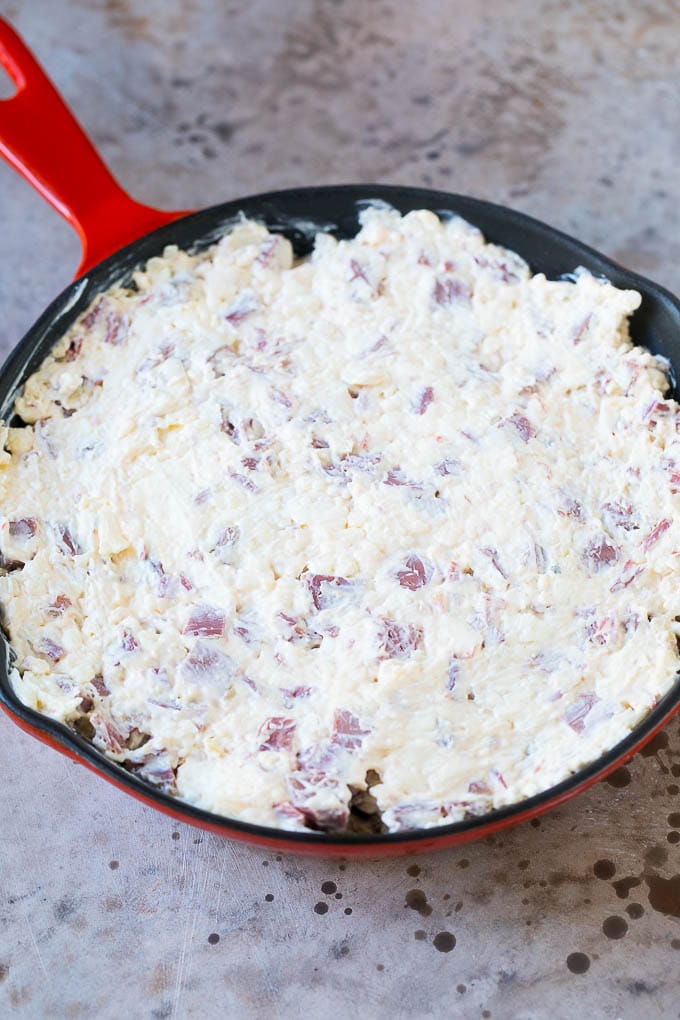 Reuben Dip Recipe | Corned Beef Dip | Cheese Dip #dip #cheese #cornedbeef #appetizer #lowcarb #keto #bajap Cream cheese, corned beef and other ingredients spread into a skillet for baking.