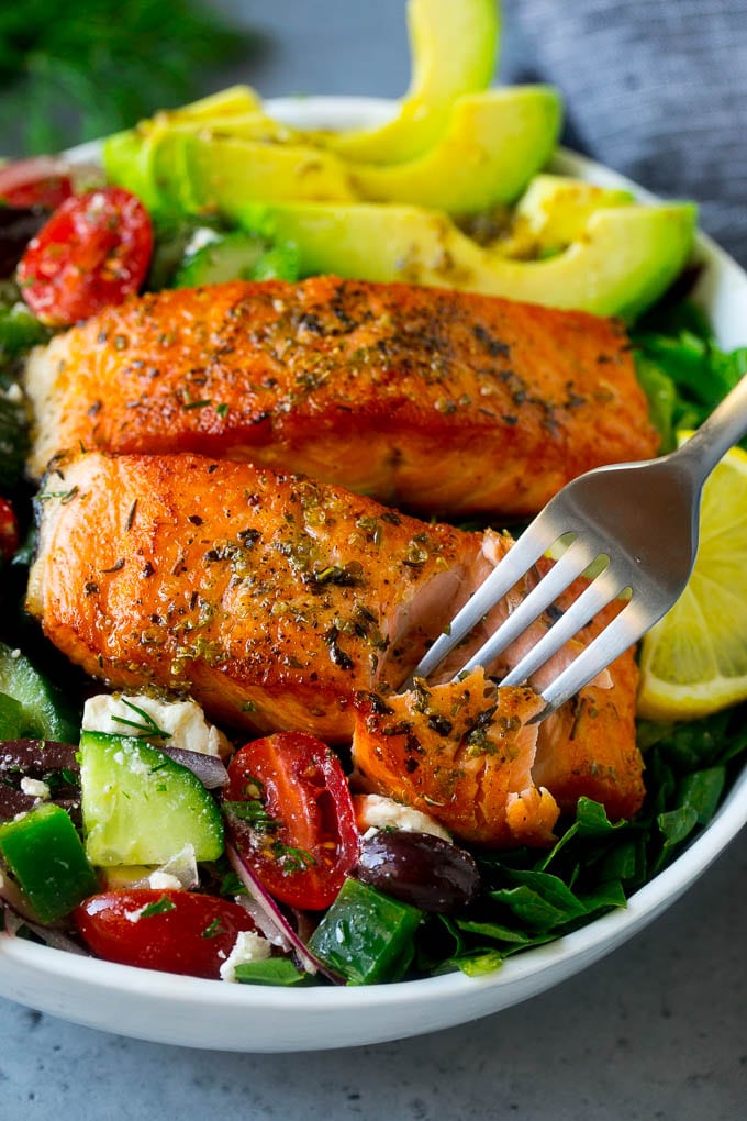 Greek Salmon Salad Recipe | Low Carb Salmon Recipe | Salmon Salad #salmon #seafood #fish #lowcarb #keto #lunch #bajap #healthy A fork cutting into a salmon fillet in Greek salmon salad.