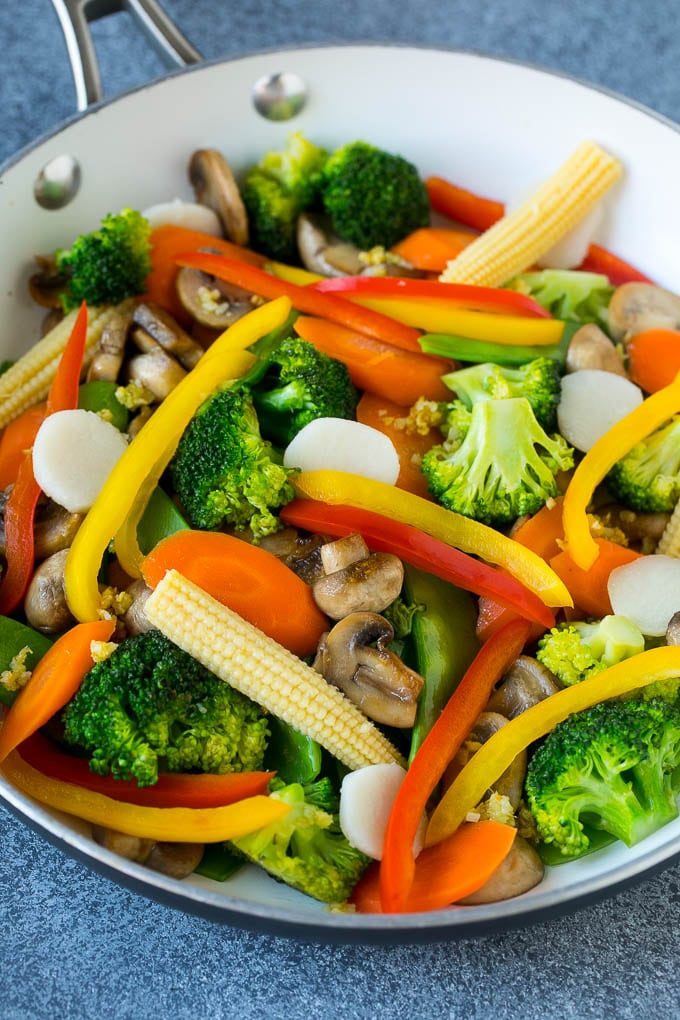 Vegetable Stir Fry Recipe | Veggie Stir Fry | Broccoli Stir Fry #vegetarian #vegetables #broccoli #dinner #bajap A pan of sauteed baby corn, water chestnuts, peppers, broccoli and mushrooms.