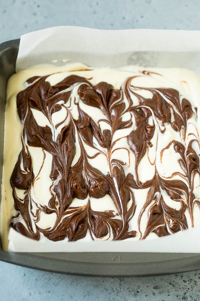 Cheesecake Brownies Recipe | Cream Cheese Brownies | Homemade Brownies #brownies #cheesecake #chocolate #dessert #bajap Swirled chocolate and cream cheese brownie batters in a baking pan.