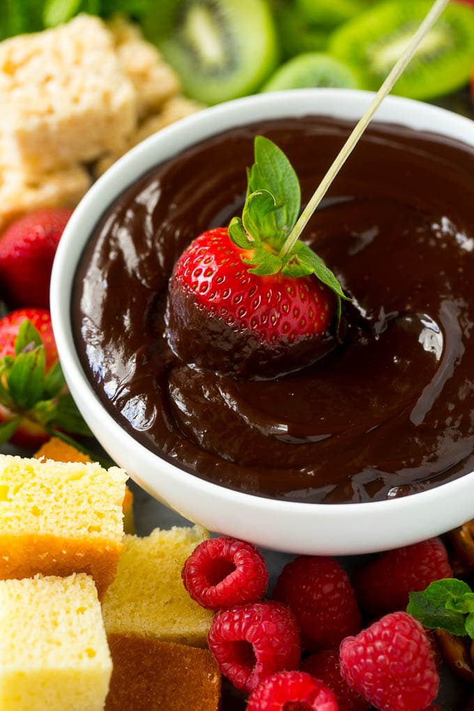 Chocolate Fondue Recipe | Chocolate Sauce | Chocolate Dip #chocolate #dessert #glutenfree #fondue #bajap A strawberry on a skewer dipped into a bowl of chocolate fondue.