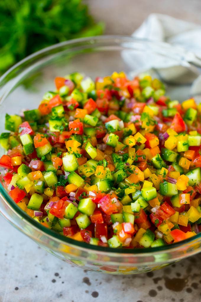 Israeli Salad Recipe | Cucumber Salad | Tomato Salad | Chopped Salad #salad #cleaneating #healthy #glutenfree #lowcarb #keto #sidedish #lunch #bajap Israeli salad with cucumbers and tomatoes in a serving bowl.